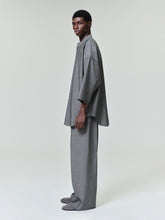 male model in relaxed fit grey wide-leg cotton wool oxford pants paired with oversized tunic top