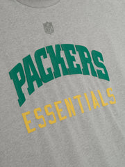 Close-up of concrete heather Packers 90s 3/4 Sleeve Football Tee showing green PACKERS and yellow ESSENTIALS text on chest