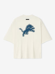 Back view of cream white Lions 90s 3/4 Sleeve Football Tee featuring large blue leaping lion graphic centered