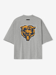 Back view of concrete heather Bears 90s 3/4 Sleeve Football Tee featuring large orange and navy roaring bear head graphic centered