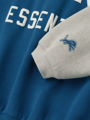 Close-up of Lions Sport Hoodie in blue sapphire with heather stone sleeve and small blue Lions logo patch on cuff