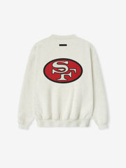 Back view of a light gray Forty Niners Sport Crewneck featuring a large red and black oval "SF" logo centered on the upper back, with ribbed cuffs and hem.