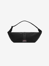 Essentials Shell Bag in black with a curved shoulder strap central zip closure and small woven label displayed against a clean white background