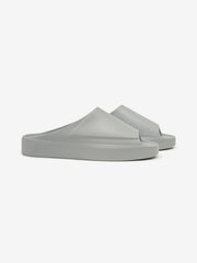 Essentials Los Feliz footwear in a muted grey tone, featuring a smooth, slip-on design with a futuristic molded upper and thick cushioned sole for relaxed casual wear.