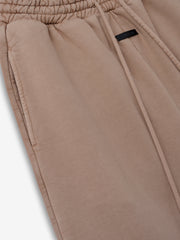 close-up of sunfaded beige heavyweight cotton fleece sweatpant with elastic waistband and side seam pocket