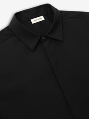 close-up of black cotton wool oxford classic shirt with pointed collar and hidden button placket detail