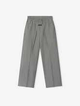 Flat lay of gray wide-leg pants with elastic waistband and long drawstrings on a white background