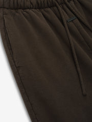 close-up of dark brown heavyweight cotton fleece fabric with elastic waistband and drawstring on womens sweatpants