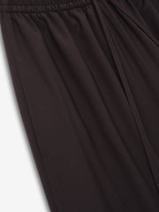 close-up of dark superfine wool canvas drawstring pants with elasticated waistband and relaxed wide-leg fit for women