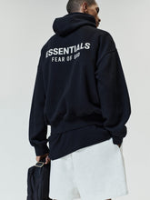 Essentials FW26 Classic Hoodie in black shown from the back on a model with hood ribbed cuffs and bold Fear of God Essentials back branding Tops