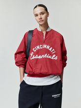 Reds Half Zip Pullover in a vibrant red shade featuring white "Cincinnati Essentials" script on lightweight outerwear fabric with a relaxed fit and elastic cuffs.