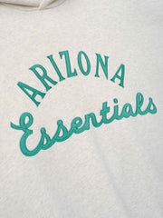 Diamondbacks Sport Hoodie in a soft oatmeal heather color featuring raised teal embroidery with "ARIZONA Essentials" text on cozy outerwear fabric.