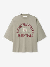 Phillies NL Merch Tee in a muted taupe fabric featuring maroon "Philadelphia Phillies Essentials" text arched over a vintage-style logo, designed as a casual, relaxed-fit top.