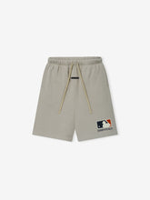 MLB 90s Short in light beige featuring an elastic waistband with matching drawstrings and a bold MLB Essentials logo on the lower leg, styled for casual bottoms.