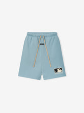 MLB 90s Short in soft stone blue fabric featuring beige drawstrings and an elastic waistband, styled with a relaxed fit and a subtle Essentials logo patch on the leg for casual bottoms.