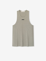 Essential Tank in a muted heathered taupe shade featuring a relaxed sleeveless cut, scoop neckline, and a subtle horizontal black logo patch for a casual, modern top.