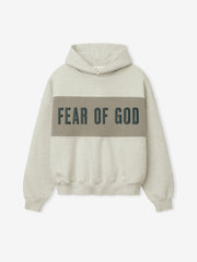 Cropped Relaxed Panelled Hoodie in a light beige tone with a wide muted olive panel across the chest featuring bold Fear of God lettering, designed with ribbed cuffs and hem for a relaxed fit.