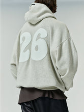 90'S Zip-Up Hoodie in a light neutral tone featuring an oversized fit with dropped shoulders and large bold white numbers printed on the back.