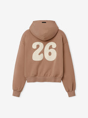 Womens 90s Full Zip Hoodie in a warm washed ginger shade featuring a relaxed fit, attached hood, ribbed cuffs, and a bold cream-colored "26" graphic on the back for a vintage-inspired outerwear look.