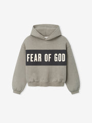 Kids Cropped Relaxed Panelled Hoodie in a muted heather grey tone with a wide dark grey panel across the chest featuring bold "Fear of God" lettering, designed as a cozy kids outerwear top.