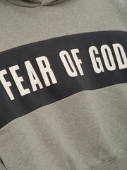 Kids Cropped Relaxed Panelled Hoodie in a muted grey with a wide dark grey panel across the chest showcasing bold "Fear of God" lettering for a trendy kids outerwear top.