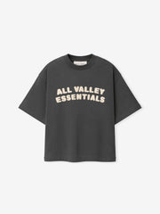 Kids Merch Tee in dark gray fabric featuring cream-colored bold text "ALL VALLEY ESSENTIALS" in playful rounded font across the chest for a casual kids top.