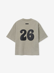 Kids Merch Tee in muted gray fabric featuring a large black number "26" in a rounded font on the back, designed for a relaxed and sporty kids' top.