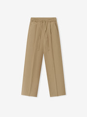 Womens Cotton Twill Pleat Front Drawstring Pant in a warm dune shade, featuring front pleats, an adjustable drawstring waistband with elastic, and a relaxed straight-leg cut for versatile bottoms.