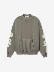 90'S Sweatshirt in a washed seal grey tone, featuring a relaxed fit with dropped shoulders, ribbed cuffs and hem, a front kangaroo pocket, and bold cream print on the sleeves.