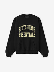 Steelers 90s Relaxed Crewneck black sweatshirt with cream Pittsburgh Essentials collegiate lettering kangaroo pocket and ribbed cuffs shown as a Tops product view