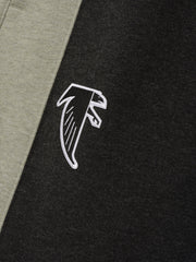 Falcons Lounge Sweatpant close up in black fleece with gray side panel and white embroidered falcon emblem shown as a Bottoms product detail