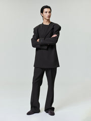 male model in black double-weave virgin wool tailored high-waisted flared pants with matching structured jacket