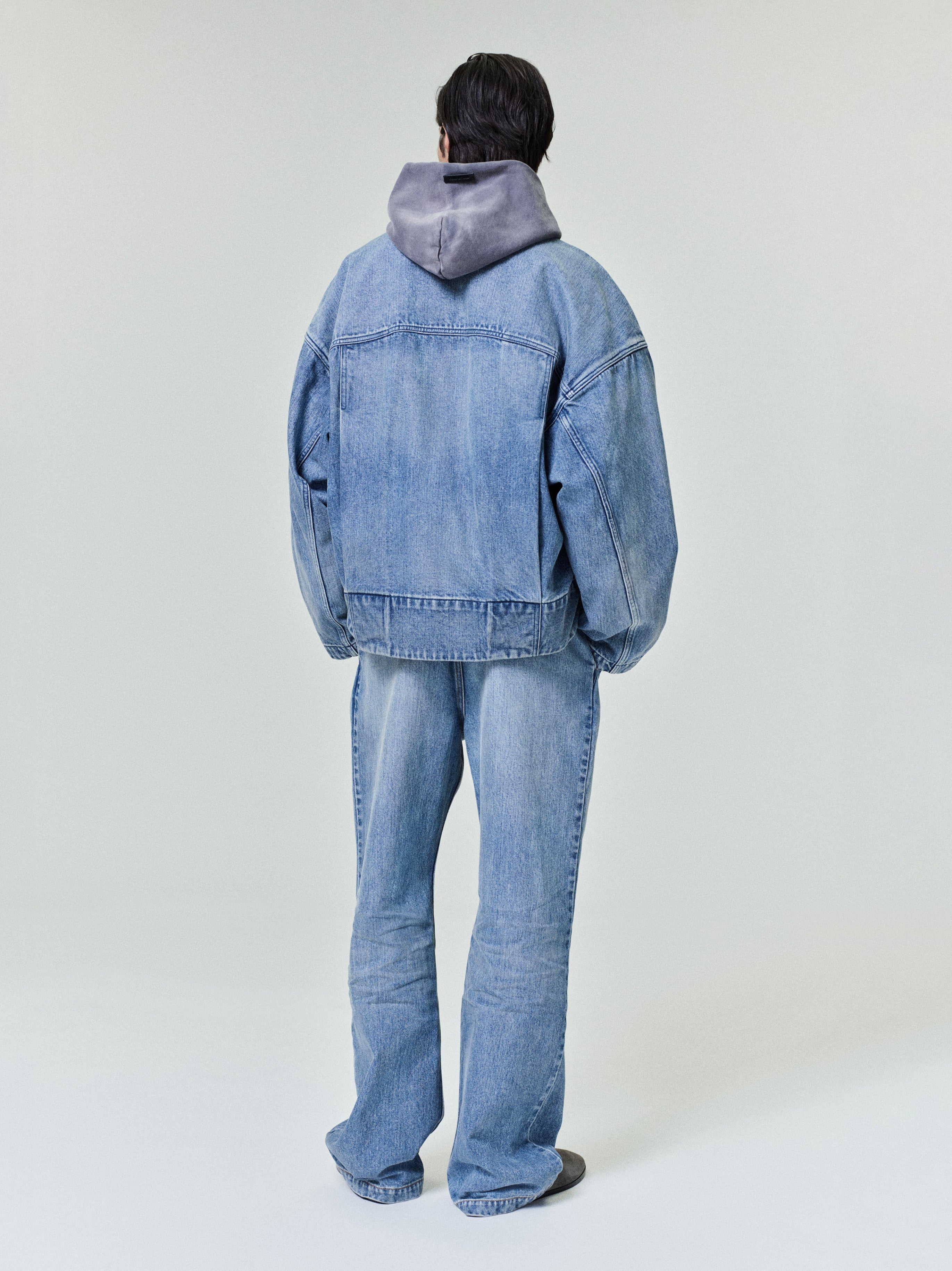 back view of men's classic blue indigo denim jacket with relaxed fit and slightly dropped shoulders