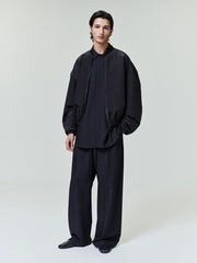 model wearing black lightweight nylon taffeta padded bomber jacket with elastic cuffs and knit collar