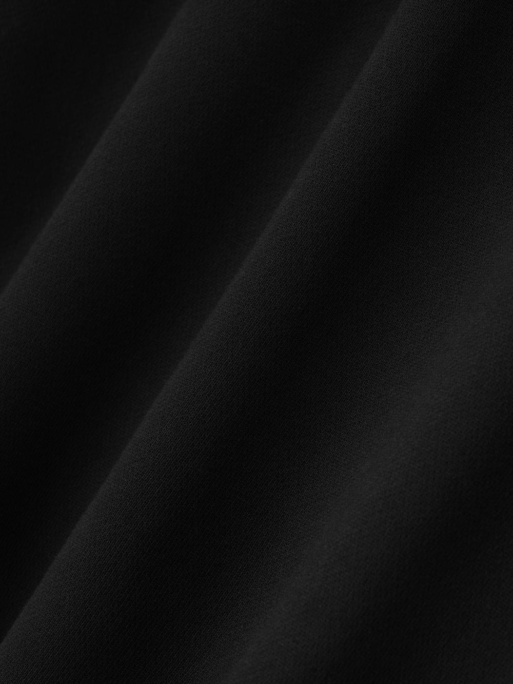 Close-up of smooth black fabric texture on Berlin 90's Hoodie showing soft material detail, gallery position 0