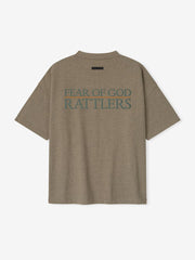 Rear view of brown FAMU 90s Tee featuring large teal "FEAR OF GOD RATTLERS" text and minimal black label above, file 3YwJGyfA.jpg