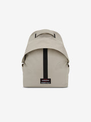 Essentials Backpack in beige shown from the front with a top carry handle central black zipper and rectangular logo patch on a clean white background
