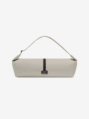 ESSENTIALS SHELL BAG LARGE in light beige with a long curved shoulder strap central black zipper and woven logo label displayed against a clean white background