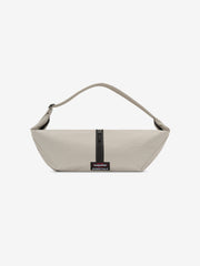 Essentials Shell Bag in light beige with a curved shoulder strap central black zipper and small woven label displayed against a clean white background