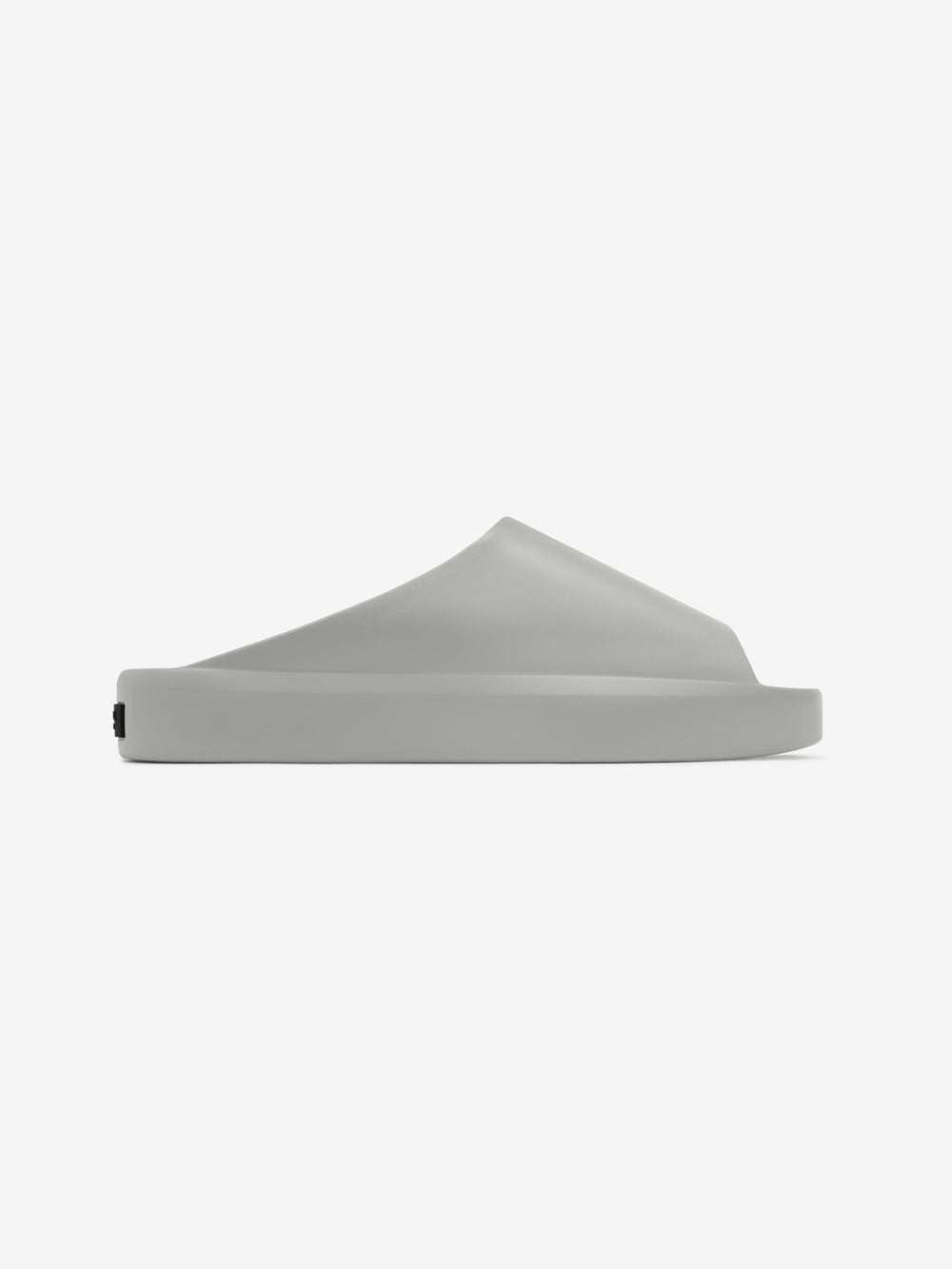 Essentials Los Feliz footwear in a soft grey finish, featuring a smooth slip-on design with a seamless, sculpted upper and a thick, cushioned sole for everyday casual wear.