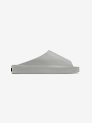 Essentials Los Feliz footwear in a soft grey finish, featuring a smooth slip-on design with a seamless, sculpted upper and a thick, cushioned sole for everyday casual wear.