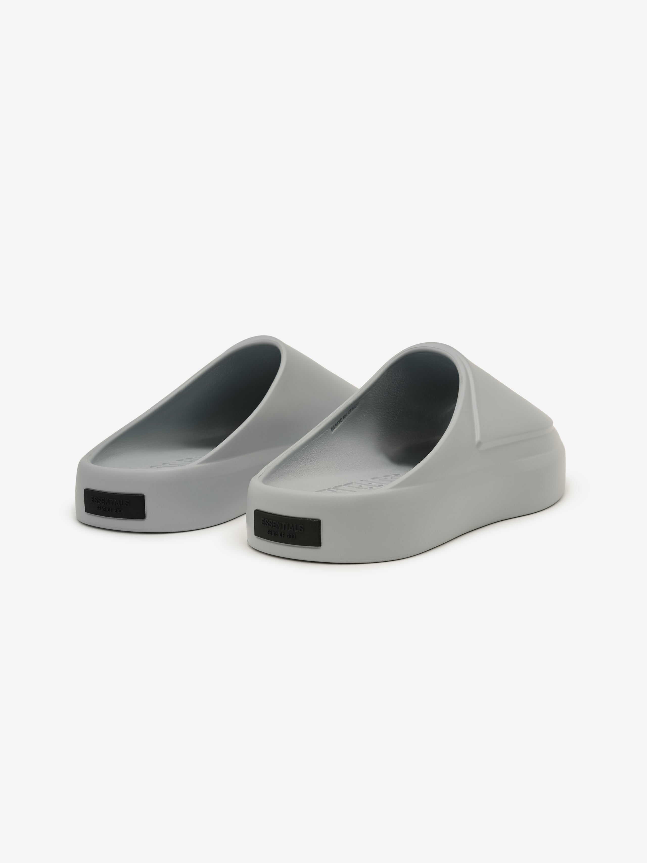 Essentials Los Feliz footwear in a smooth slate grey shade, featuring a streamlined slip-on style with a rounded toe and a thick, cushioned sole for everyday casual comfort.