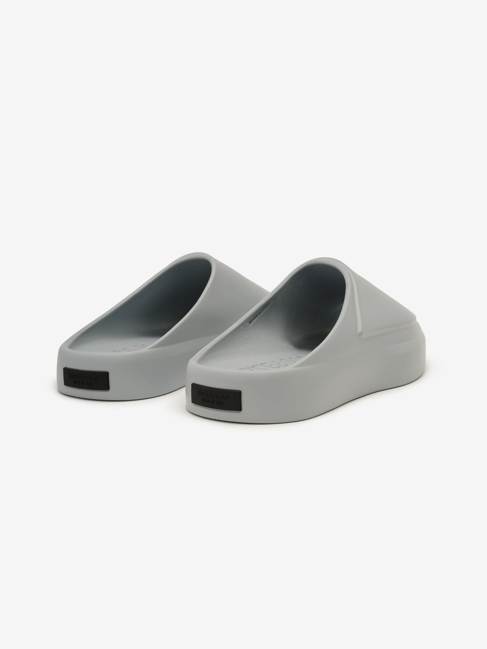 Essentials Los Feliz footwear in a smooth slate grey shade, featuring a streamlined slip-on style with a rounded toe and a thick, cushioned sole for everyday casual comfort.