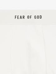 close-up of white rib-knit brief with plush elastic waistband branded Fear of God in black text