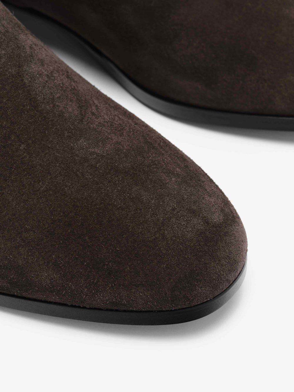 Suede Ankle Boot in deep brown featuring a soft suede upper with a smooth rounded toe and sleek black sole for a modern, versatile footwear option.