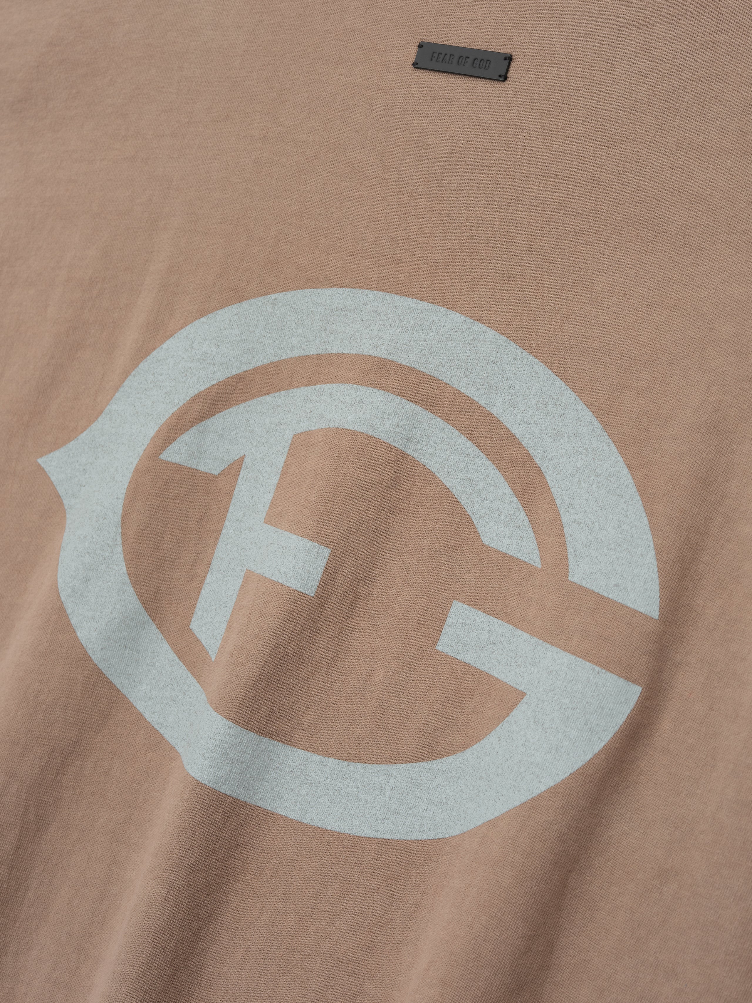 taupe heavyweight cotton tee with large distressed light gray FG insignia printed on front chest