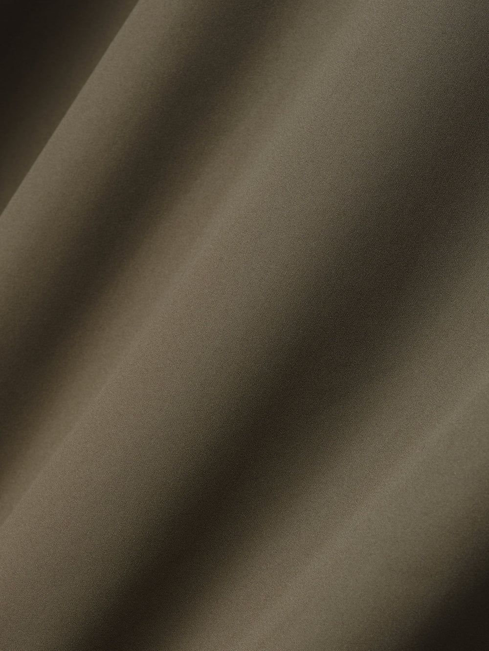 close-up of smooth olive bonded nylon microfibre fabric used in Italian tech track jacket