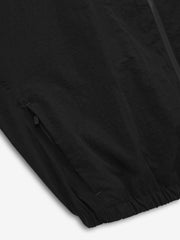 close-up of black recycled nylon ripstop fabric with zippered pocket and elasticated hem detail on jacket