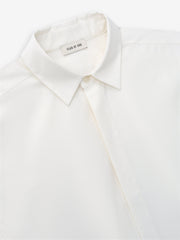 close-up of white cotton wool oxford classic shirt collar with covered button placket and Fear of God label