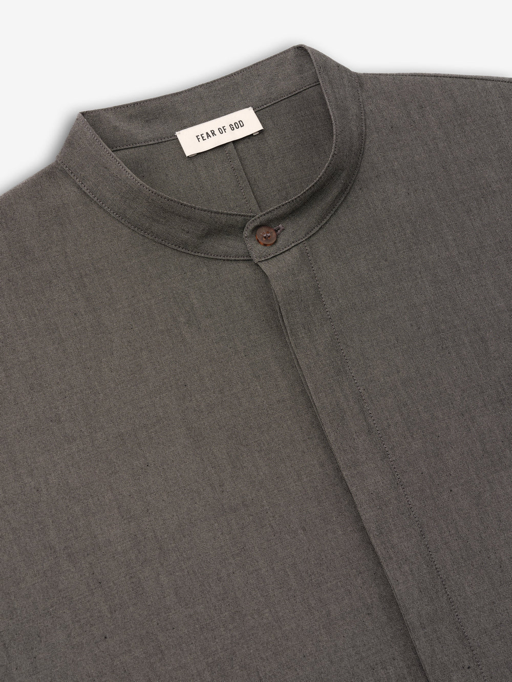 close-up of charcoal grey cotton-wool oxford shirt with mandarin collar and single button closure